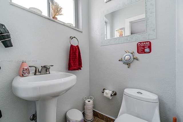 bathroom featuring sink and toilet