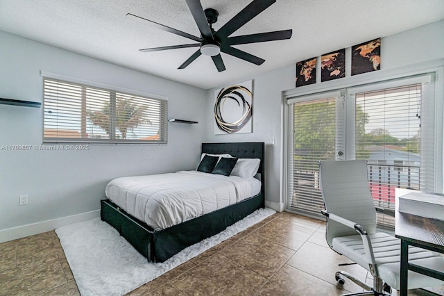 bedroom featuring multiple windows, ceiling fan, and a textured ceiling