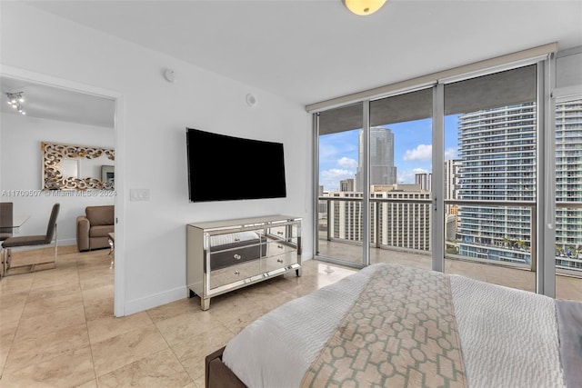 bedroom featuring access to outside and floor to ceiling windows