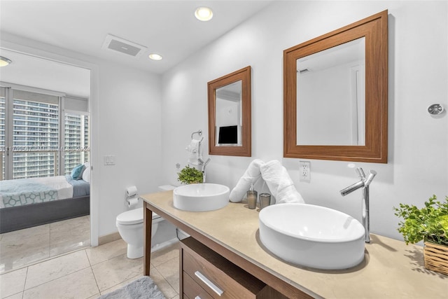 bathroom with tile patterned flooring, vanity, and toilet