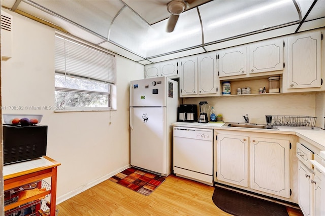 kitchen featuring white cabinetry, light wood-type flooring, white appliances, and sink