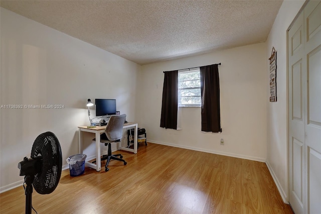 office featuring a textured ceiling and light wood-type flooring