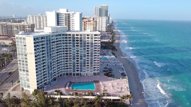 drone / aerial view featuring a water view and a beach view