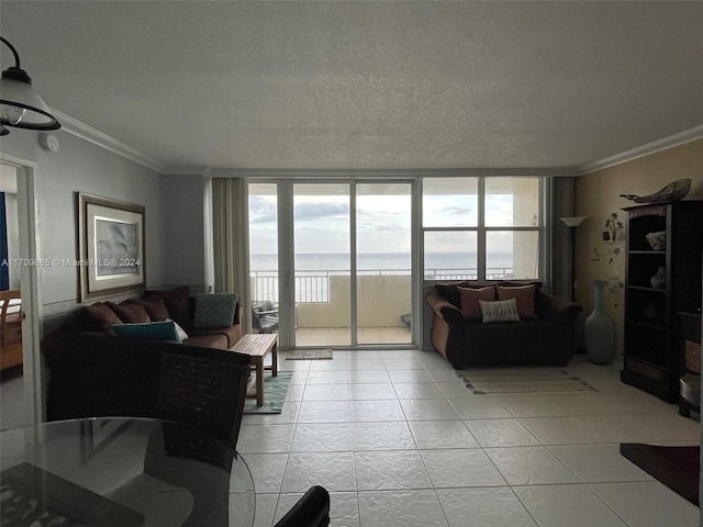 living room with a textured ceiling, a water view, floor to ceiling windows, and crown molding