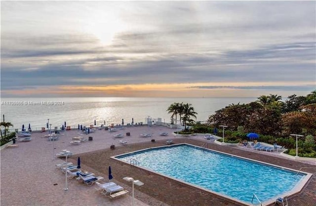 pool at dusk with a water view