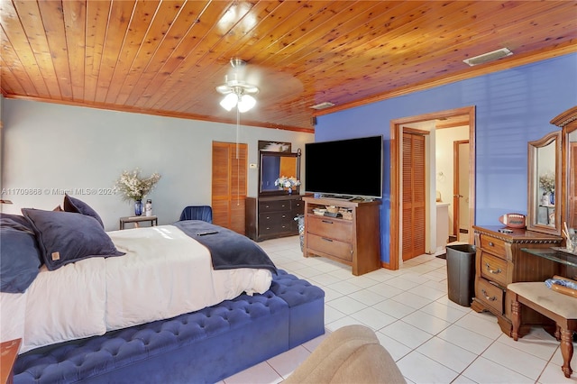 tiled bedroom featuring ceiling fan, wood ceiling, and ornamental molding