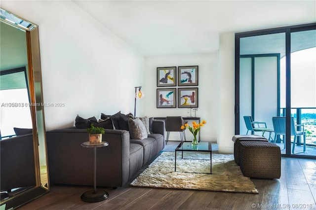 living room with expansive windows and dark hardwood / wood-style floors