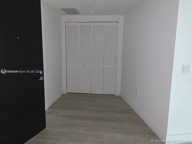 interior space with wood-type flooring and a closet