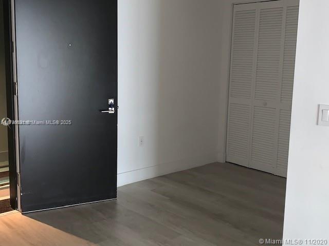 spare room featuring wood-type flooring