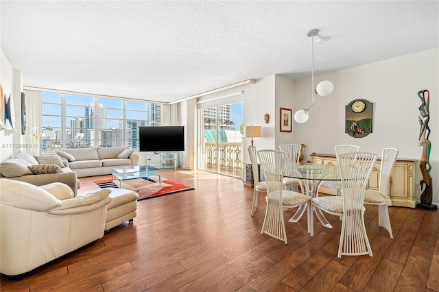 living room featuring hardwood / wood-style flooring, expansive windows, and a textured ceiling