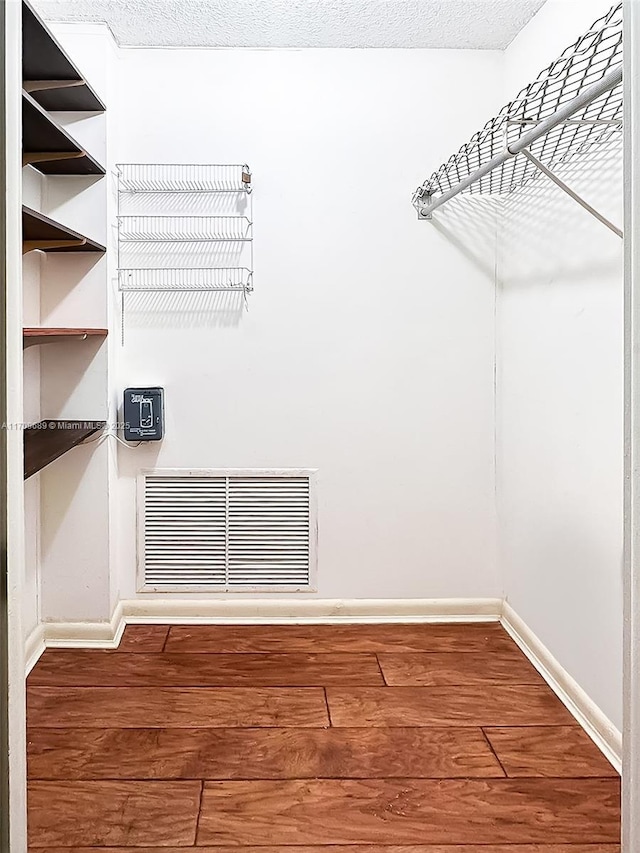 walk in closet featuring hardwood / wood-style flooring