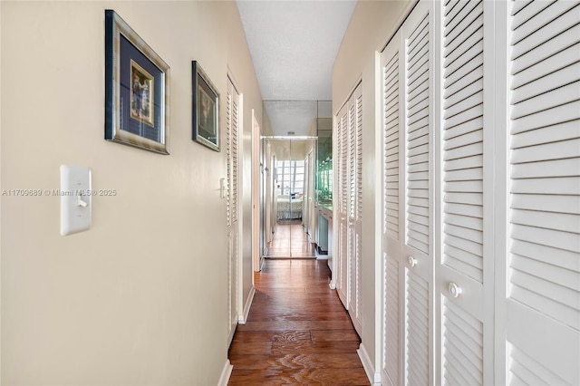 corridor featuring dark hardwood / wood-style floors and a textured ceiling