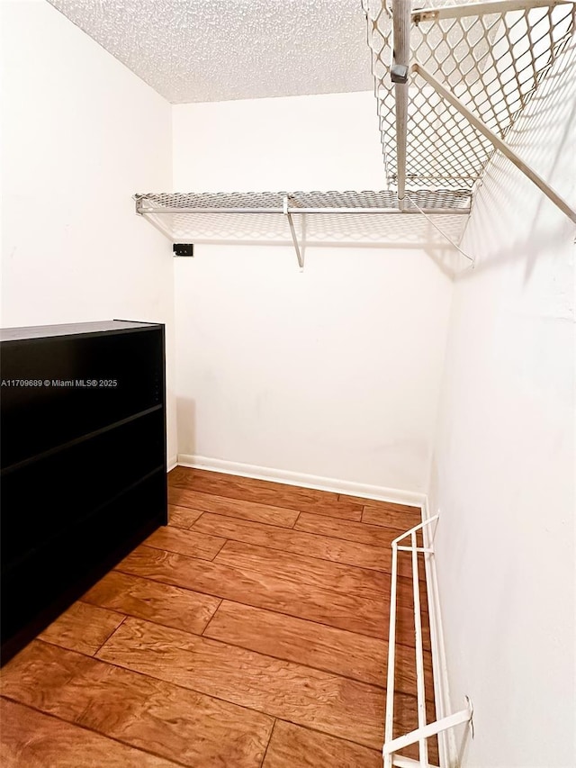 walk in closet featuring hardwood / wood-style flooring