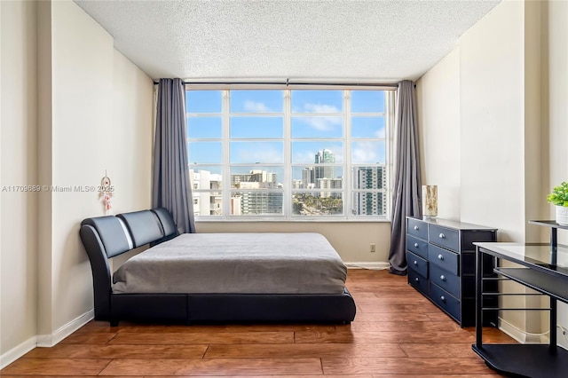 bedroom featuring wood-type flooring and a textured ceiling