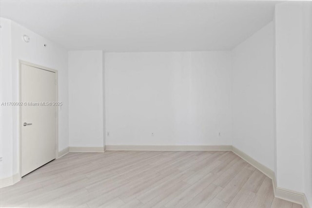 empty room with light hardwood / wood-style floors