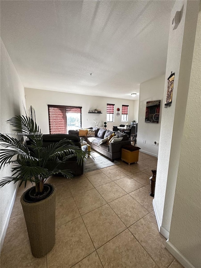 living room with light tile patterned floors and a textured ceiling