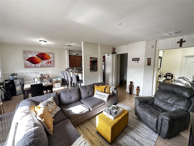 tiled living room with a textured ceiling