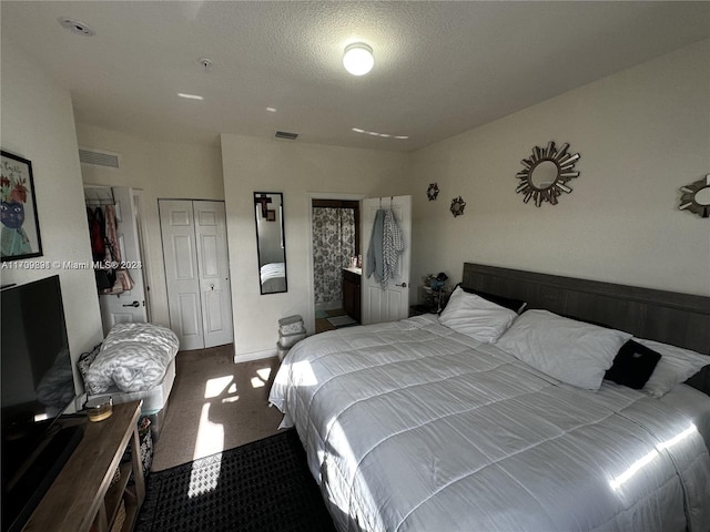 carpeted bedroom with a textured ceiling