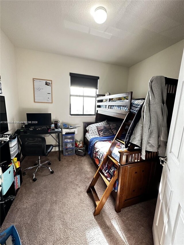 carpeted bedroom with a textured ceiling