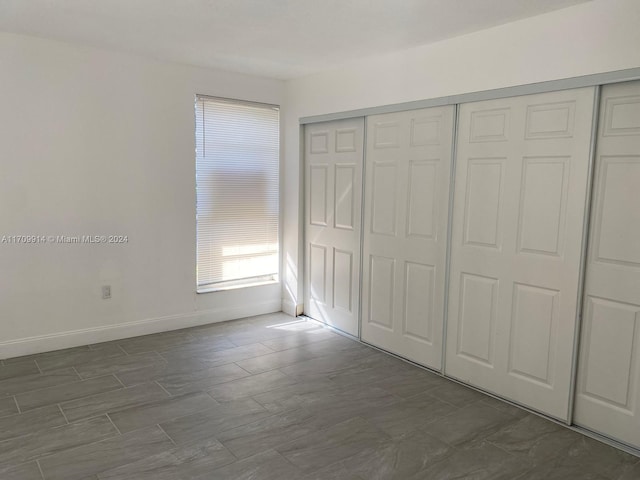 unfurnished bedroom with a closet