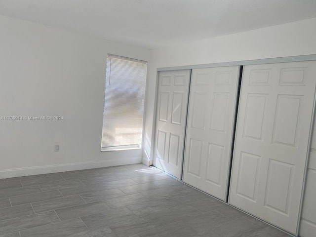 unfurnished bedroom featuring a closet