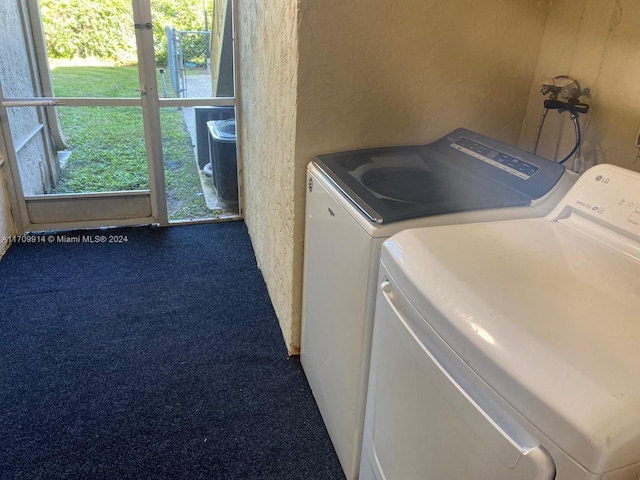 laundry area featuring washing machine and dryer and carpet