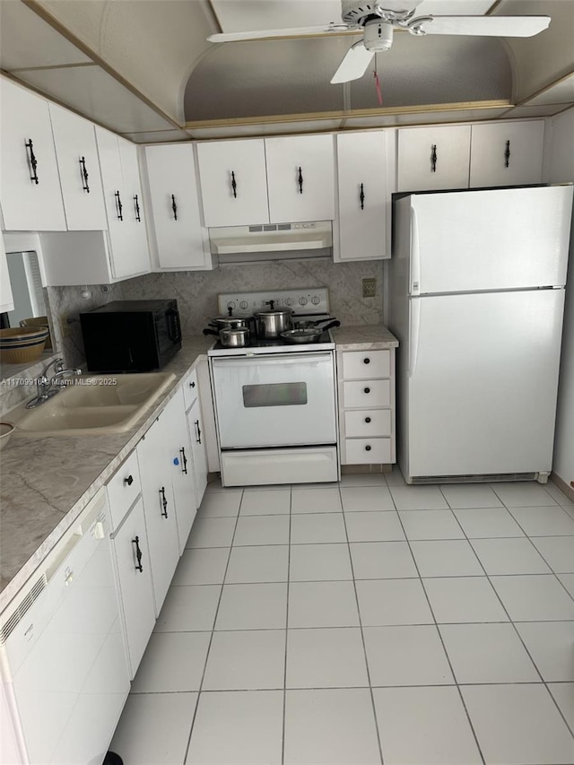 kitchen featuring light countertops, white cabinetry, a sink, white appliances, and under cabinet range hood