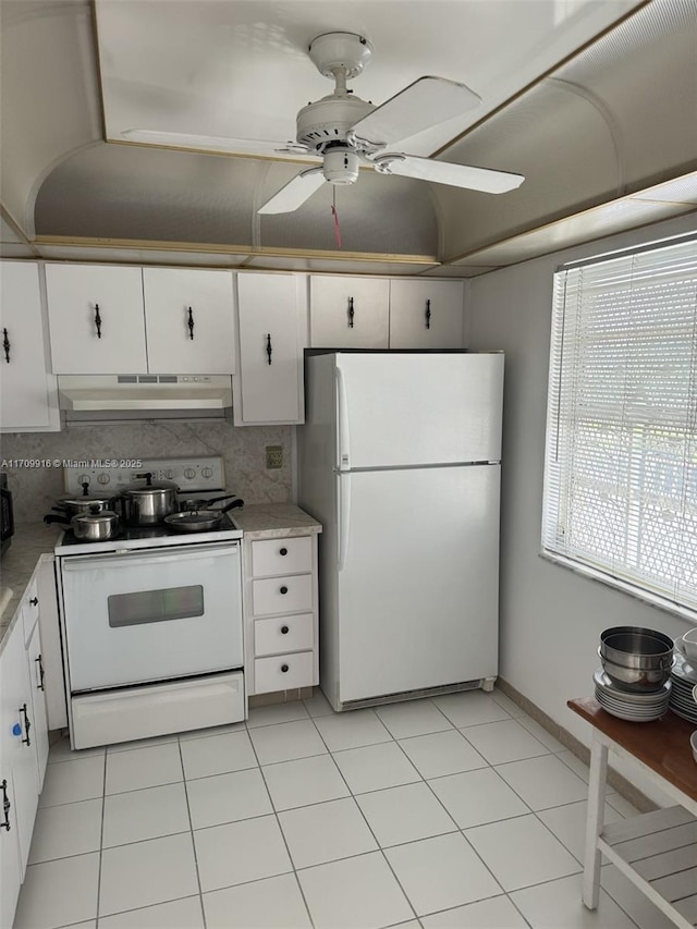 kitchen featuring light countertops, white appliances, white cabinets, and under cabinet range hood