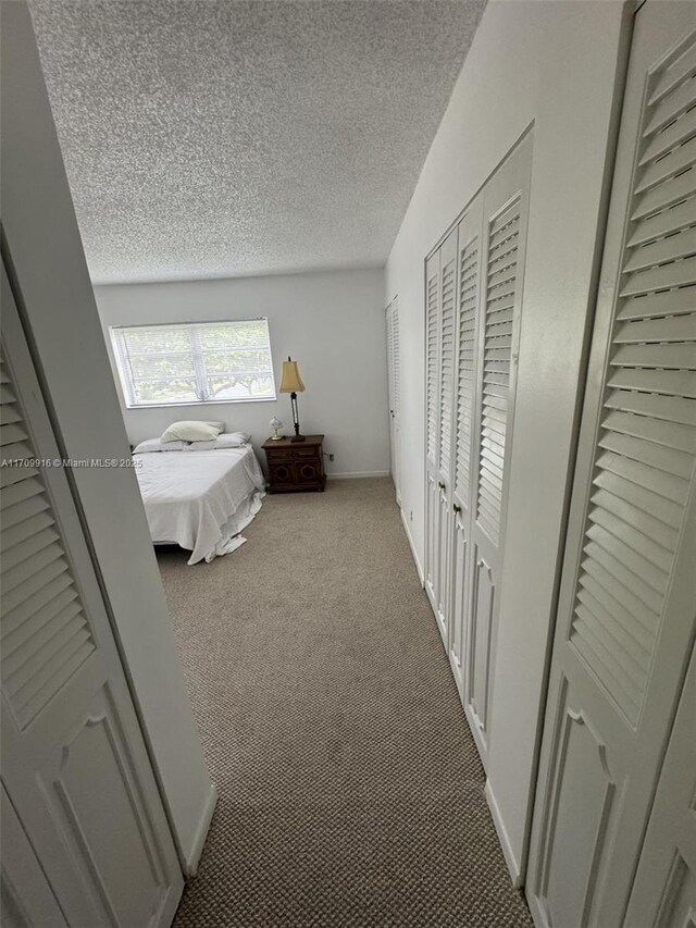 unfurnished bedroom featuring a textured ceiling and carpet floors