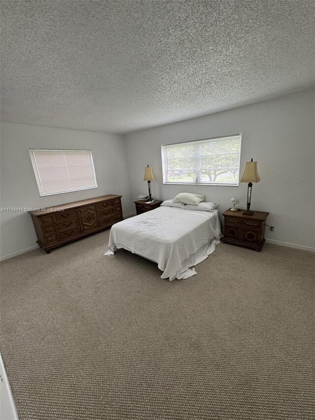 carpeted bedroom featuring a textured ceiling