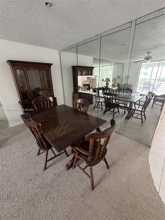 dining room featuring a textured ceiling and a ceiling fan