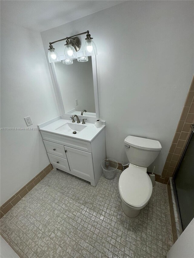 bathroom with tile patterned floors, vanity, and toilet