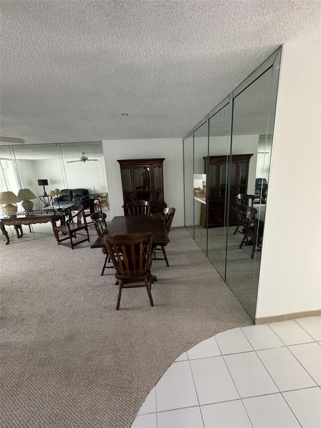 dining area featuring tile patterned floors and a textured ceiling