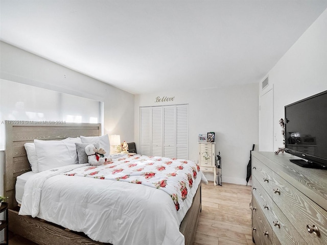 bedroom featuring light wood-type flooring and a closet