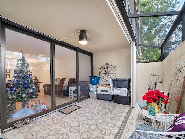 sunroom with ceiling fan and a healthy amount of sunlight