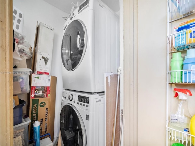 clothes washing area featuring stacked washer / dryer