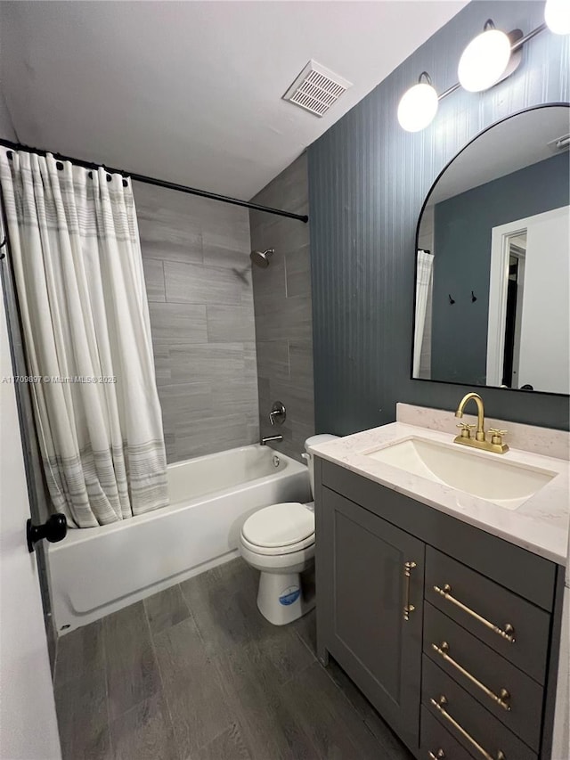 full bathroom featuring wood-type flooring, toilet, shower / tub combo, and vanity