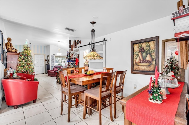 dining room featuring light tile patterned floors and vaulted ceiling