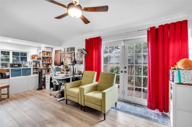 sitting room with ceiling fan, light hardwood / wood-style flooring, and french doors