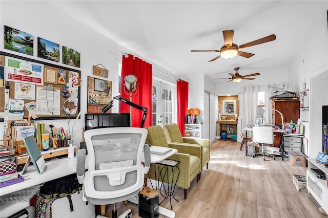 living room featuring ceiling fan and light hardwood / wood-style floors