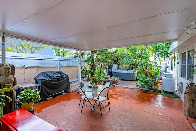 view of patio with grilling area and a hot tub