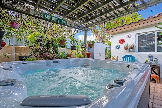 view of pool featuring a pergola and a hot tub