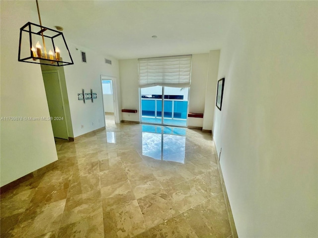 empty room featuring a notable chandelier