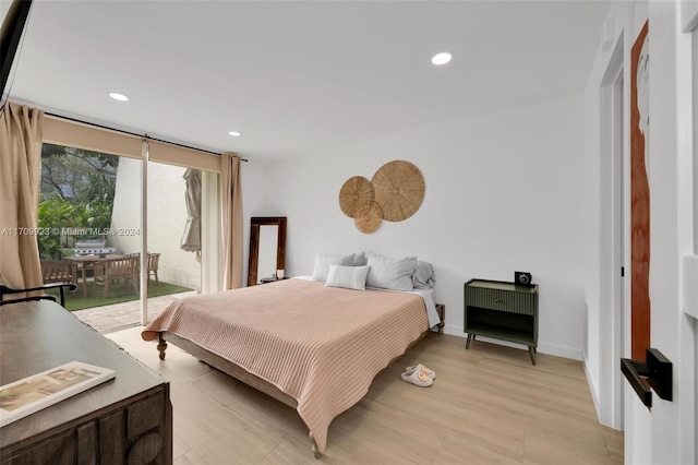 bedroom featuring light hardwood / wood-style floors and access to exterior