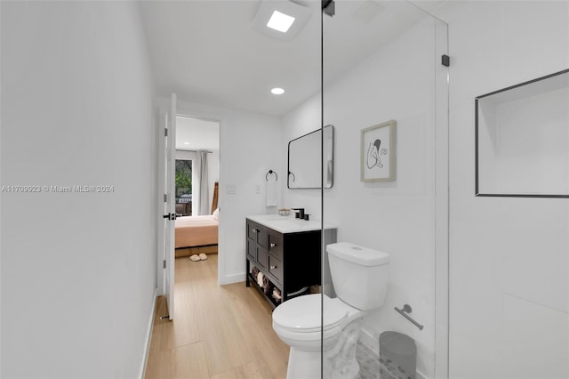 bathroom featuring vanity, hardwood / wood-style flooring, and toilet