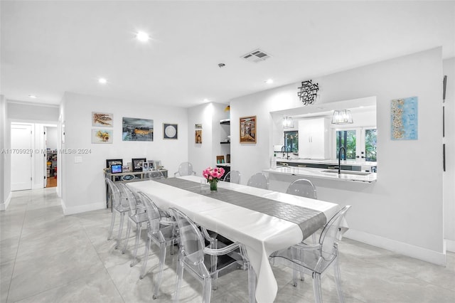 dining space featuring sink and french doors