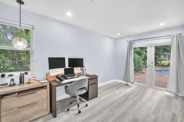 office space featuring french doors and light hardwood / wood-style flooring