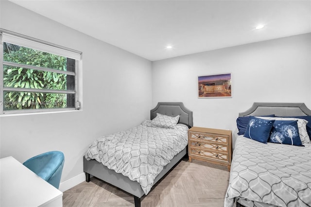 bedroom with light parquet flooring