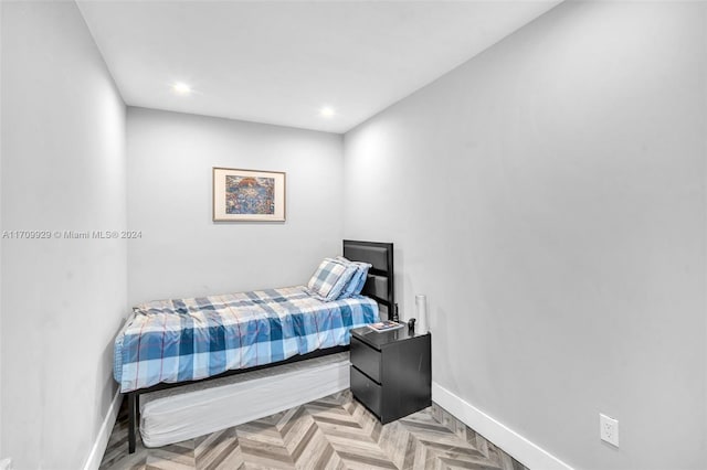 bedroom with light parquet flooring