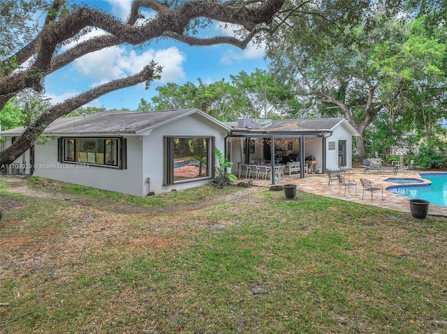 rear view of property with a patio area and a lawn